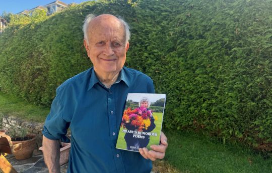 Dennis Keam with his late wife's collection of poetry. Hilary was a Cornish bard.