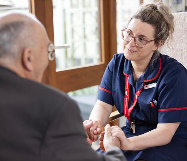 Ward Sister Anna with Patient 600 x 515 Ward Sister holding hands with a patient